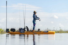 Load image into Gallery viewer, Angler stands on the Hobie Outback Fishing Kayak in calm water casting into the shoreline
sku:27100001-23